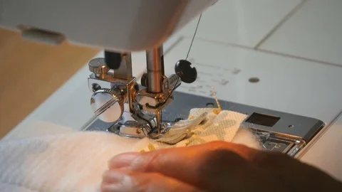 Expert female hands using sewing machine stitching fabic togeather to make arts Stock-Footage 77170516