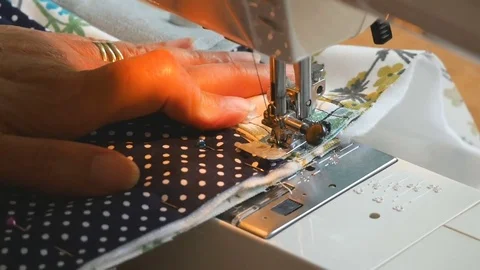 Expert female hands using sewing machine stitching fabic togeather to make arts Stock Footage 77171904