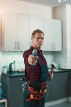 Expert in this field. Man solves household problems Stock Photos