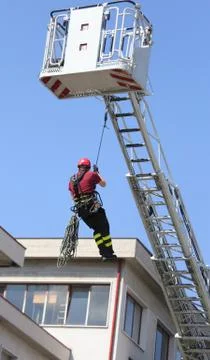 Expert firefighter down with the rope in the building Fotos de archivo