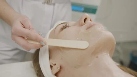 Expert girl performs permanent makeup application in beauty salon setting Stock Footage 314256871