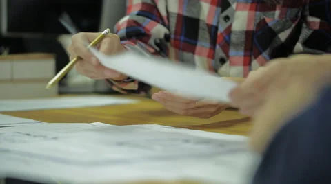 Expert group of people pass each other papers and is a lively discussion of the Video stock 57545726