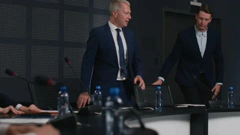 Expert group taking seats and working together at official event. Political spea Stock Footage 199482915