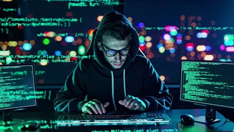 Expert hacker at night coding with multiple screens in a high-tech workspace Stock Footage 297469605