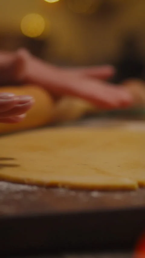 Expert hands rolling out fresh dough in a cozy kitchen during afternoon baki Stock Footage 331570322