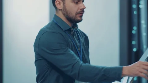 Expert IT engineer opening rack server, diagnosing supercomputer secure storage Stock Footage 121224214