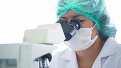 The expert Laboratory technicians use microscopes to analyze air samples. Stock Footage 336583753