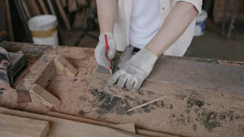 Expert male carpenter active is using electric machine sawing wood Stock Footage 249984036