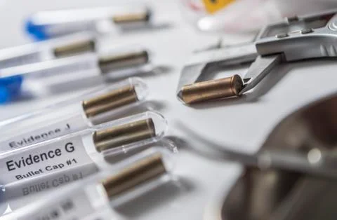 Expert Police measures bullet caliber in ballistic lab, conceptual image Stock Photos