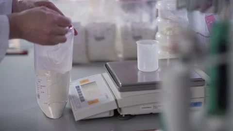 Expert pours flour into a measuring cup and weighs it close up Stock-Footage 130356710