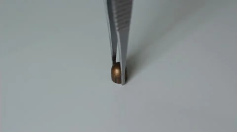 Expert puts a bullet on a table Stock Footage 66755578