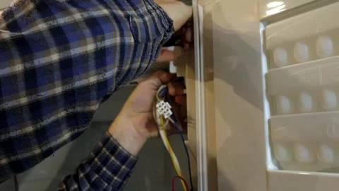 Expert refrigerator repair techniques demonstrated for common issues Stock Footage 337360654