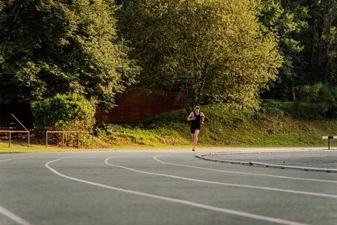 Expert runner using the inside lane of the track during the 400m sprint race Stock Photos