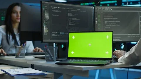 Expert in server room coding on chroma key notebook Stock Photos