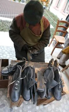 Expert shoemaker while repairing an old leather shoe Фото