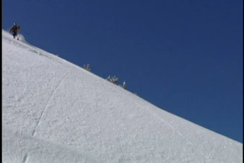 Expert skier skis down moutain Stock Footage