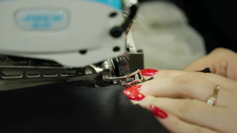 Expert Tailor Working with Overlock Sewing Machine. Tailor's hands skillfully Stock Footage 274727291
