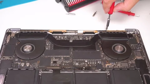 Expert technician repairs laptop components in a professional workshop setting Stock Footage 309805396