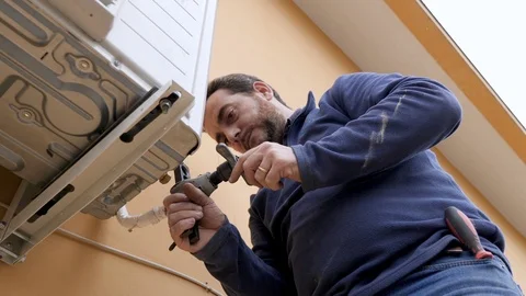 Expert technician working on the wall conditioner Stock Footage 85658781