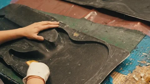 An expert using mold to laminate guitars Stock Footage 274913199