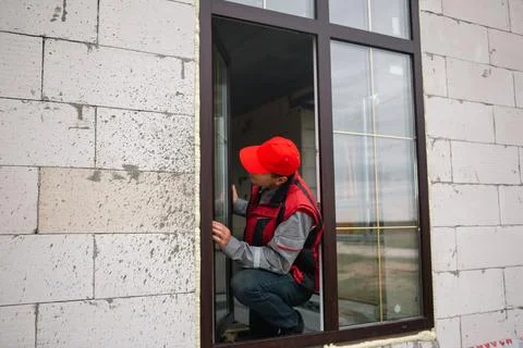 Expert window master fine-tuning new plastic window installation, detailed .. Stock Photos