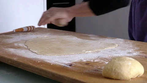 Expert woman hand using rolling pin on fresh dough Stock Footage 72934019