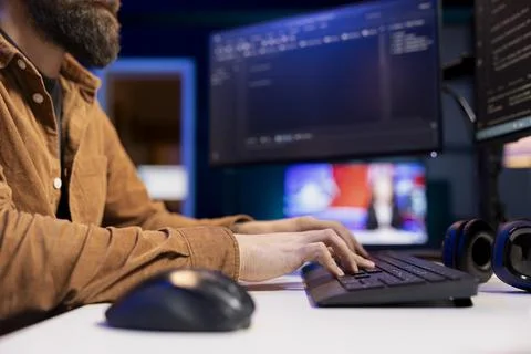 Expert writing code to build firewalls protecting company data, close up shot 스톡 사진