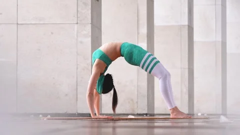 Expert yogini seamlessly blends strength, flexibility, balance. winter practice Stock Footage 241517412