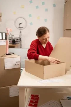 Expertly packing boxes in workspace, efficient business logistics and packa.. Stock Photos