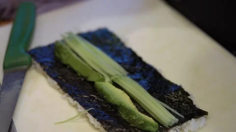 Expertly Rolling And Slicing Plantbased Sushi Using Precise Techniques In Small Stock Footage 323779029