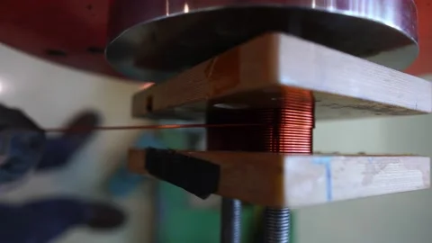 Experts are working on a coil winding machine Stock Footage 148338460