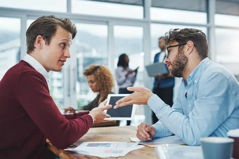 The experts in business growth. two young colleagues using a digital tablet Stock Photos