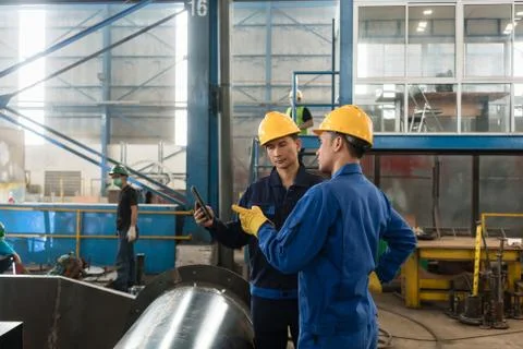 Experts checking information on tablet PC in a modern factory Stock Photos