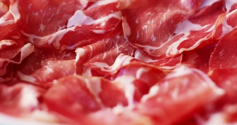 Experts hand is cutting thinly sliced a seasoned Parma salami. Stock-Footage 115327084
