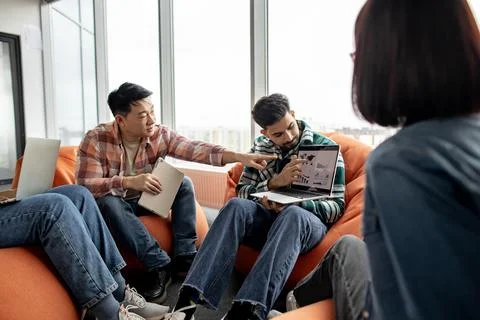 Experts talking about data on computer in office interior Stock Photos