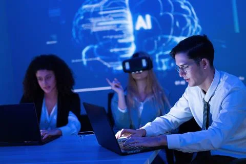 Experts in technology collaborate on artificial intelligence projects in a .. Stock Photos