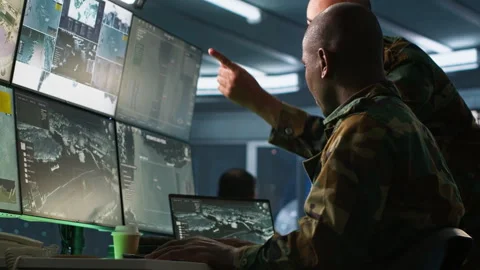 Experts using tracking gear and radar systems in command center Video stock 282136308