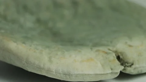 Expired sandwich bread covered in green mold, spoiled food waste with spreading Stock Footage 331314637