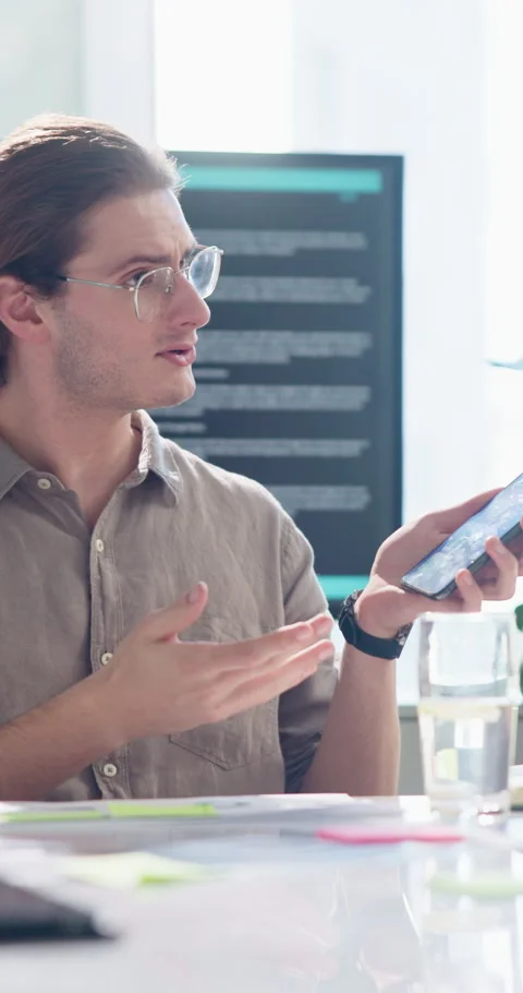 Explain, phone screen and pitch with business man in office for meeting or Stock Footage 307381985