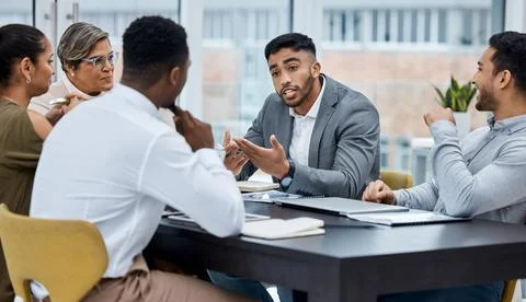 Explaining the big idea he has. a group of businesspeople having a meeting in an Stock Photos