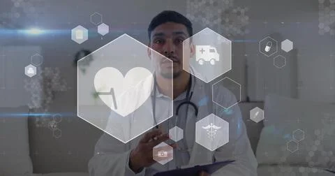 Explaining doctor in white coat and stethoscope holding tablet and gesturing in Stock Photos