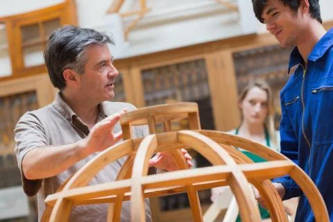 Explaining teacher in a woodwork class Stock Photos