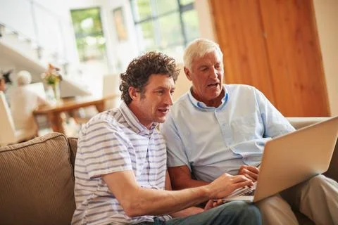 Explaining technology basics to his dad. a man and his father using a laptop Stock Photos