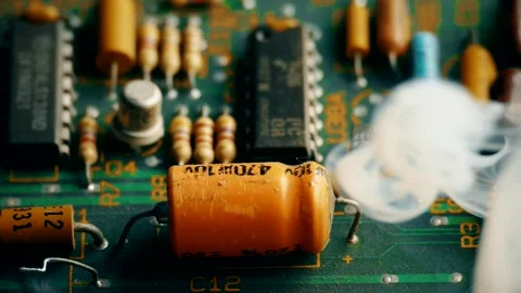 Exploded and damaged capacitor on a circuit board emitting smoke. Video stock 320711249