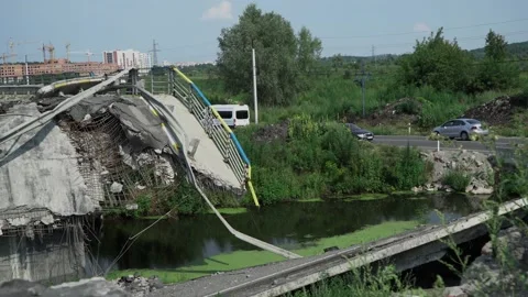 Exploded bridge in Irpin, Kyiv region after russian invaders attack. Cars drive Stock Footage 221256903