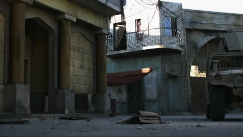 Exploded door way out into urban street from camouflage buildings - Reenactment Video stock 202902830