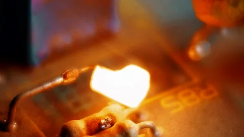 Exploded electronic component glowing brightly on a circuit board Stock Footage 320711480