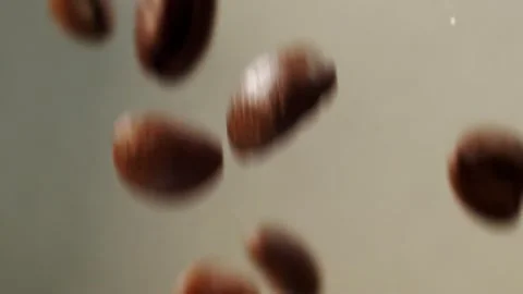 Exploded Roasted coffee beans on grey background. Slow motion shot of coffee Stock-Footage 151118538