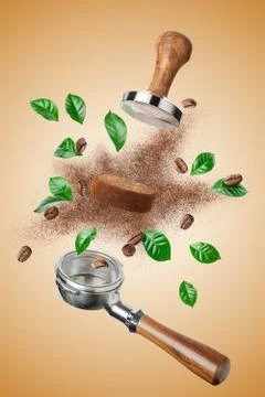 Exploded view of coffee holder and tamper with roasted beans and leaves Stock Photos