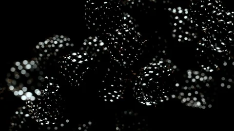 Exploding blackberries on a black background. Stock Footage